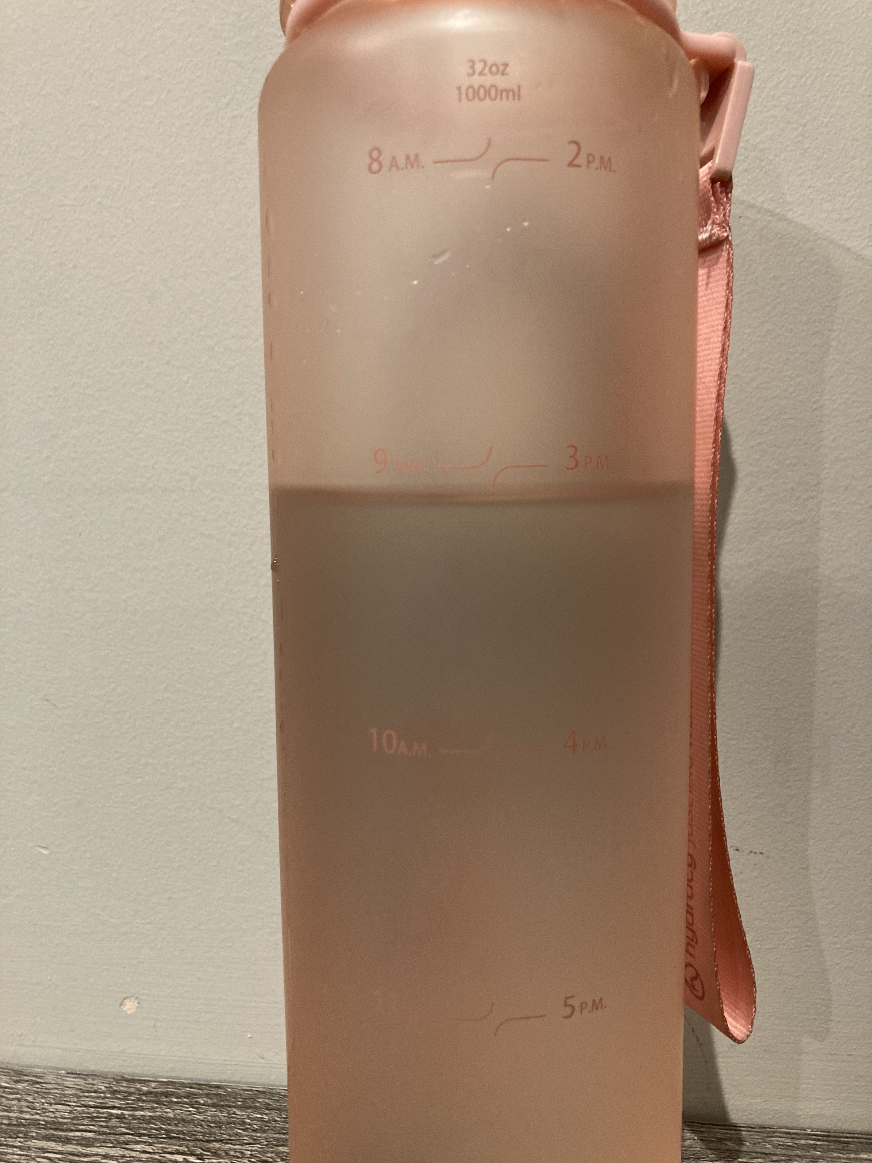 A water bottle filled to the '9am' marker